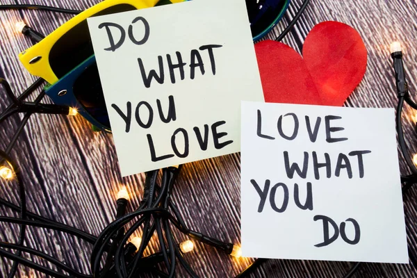 do what you love, love what you do - motivational word advice or reminder on sticky notes on cork board background