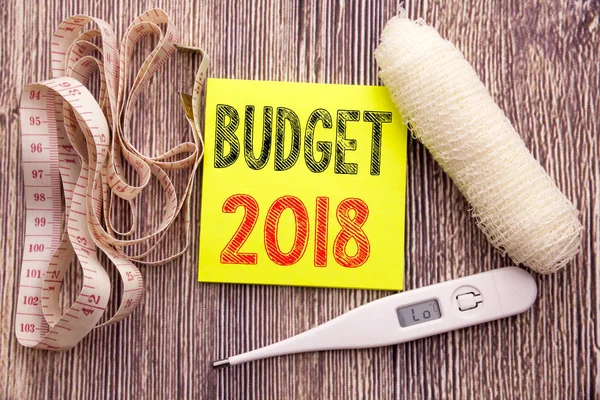 Budget 2018. Business fitness health concept for Household budgeting accounting planning written on wood wooden background with bandage and thermometer