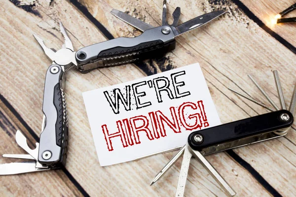 Conceptual hand writing text caption inspiration showing We Are Hiring Now. Business concept for Recruitment Human Resources  Written on sticky note wooden background with pocket knife