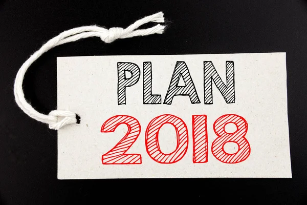 Handskriven text bildtexten visar Plan 2018. Affärsidé som skriver för planering strategi handlingsplan på prislappen papper i svart vintage bakgrunden. — Stockfoto