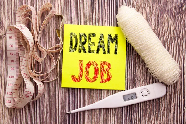 Dream Job. Business fitness health concept for Dreaming about Employment Job Position written sticky note empty paper background with copy space bandage and thermometer
