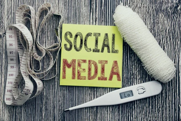 Social Media. Business fitness health concept for Community Social Media written sticky note empty paper background with copy space bandage and thermometer