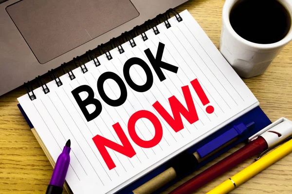 Book Now. Business concept for Reservation Booking written on notebook book on the wooden background in the Office with laptop coffee