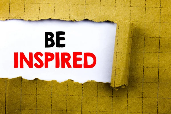Palabra, escribir Ser Inspirado. Concepto de negocio para la inspiración y motivación escrito en papel blanco sobre el papel doblado amarillo . — Foto de Stock