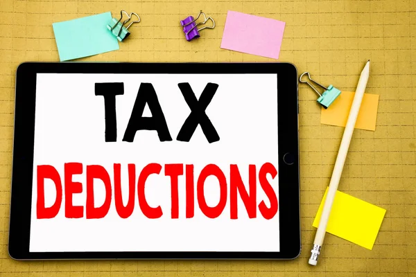Hand writing text caption inspiration showing Tax Deductions. Business concept for Finance Incoming Tax Money Deduction Written on tablet laptop, wooden background with sticky note and pen — Stock Photo, Image