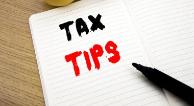 Handwritten text caption showing Tax Tips. Business concept writing for Taxpayer Assistance Refund Reimbursement written on notebook with copy space on book background with marker pen