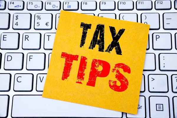 Tax Tips. Business concept for Taxpayer Assistance Refund Reimbursement written on sticky note paper on the white keyboard background.