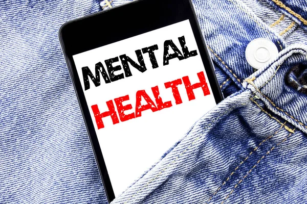 Hand writing text caption inspiration showing Mental Health. Business concept for Anxiety Illness Disorder Written phone mobile phone, cellphone placed in the man front jeans pocket.