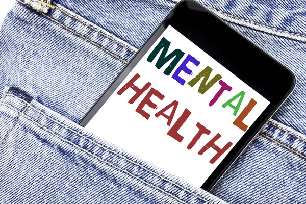 Handwriting Announcement text showing Mental Health. Business concept for Anxiety Illness Disorder Written phone mobile phone, cellphone placed in the man front jeans pocket.