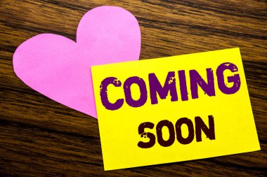 Hand writing text caption inspiration showing Coming Soon. Business concept for Message Future written on sticky note paper, wooden wood background. With pink heart meaning love adoration. clipart