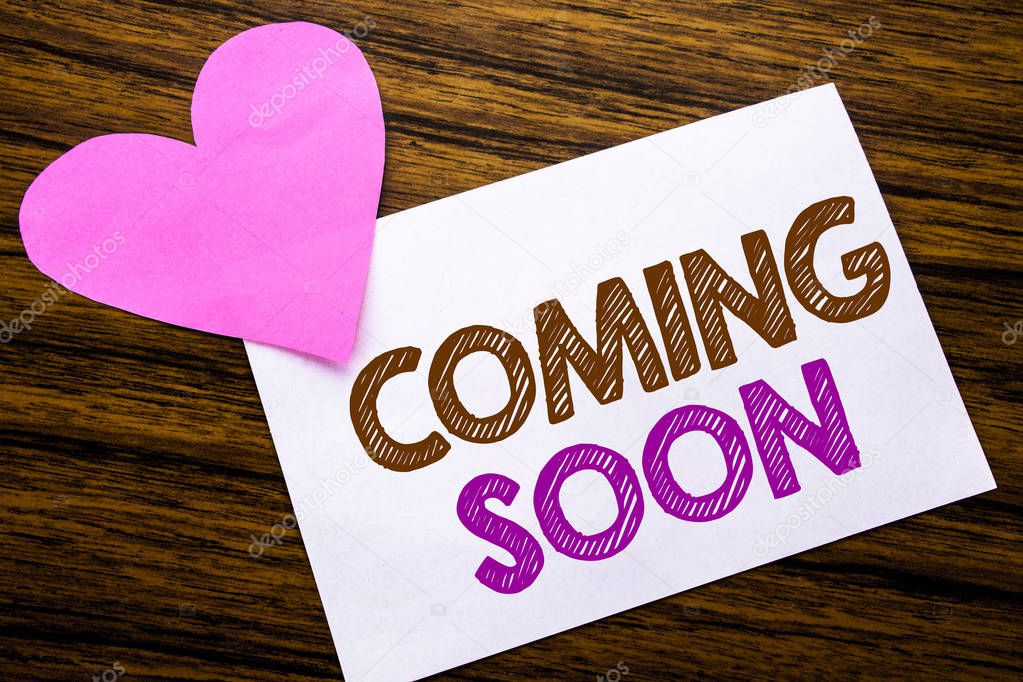 Conceptual hand writing text showing Coming Soon. Concept for Message Future written on sticky note paper, wooden wood background. With pink heart meaning love adoration.