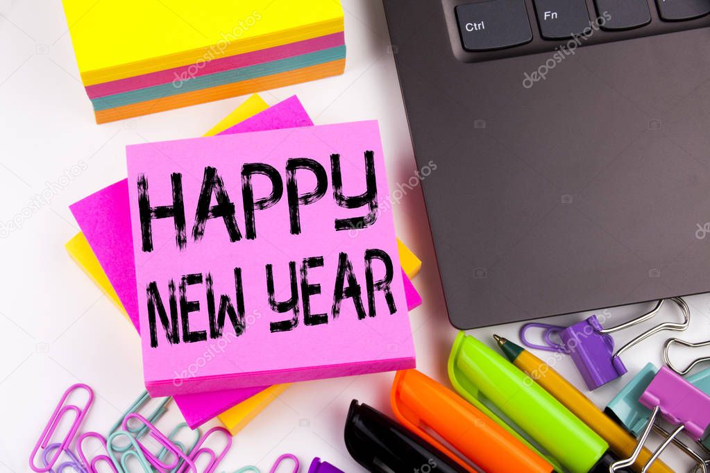 Writing text showing Happy New Year made in the office with surroundings such as laptop, marker, pen. Business concept for Christmas Celebration Workshop white background with copy space