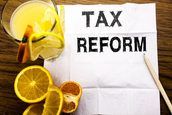 Conceptual text caption showing Tax Reform. Concept for Government Change in Taxes written on tissue paper on the wooden background with pen healthy juice and orange fruit in the restaurant