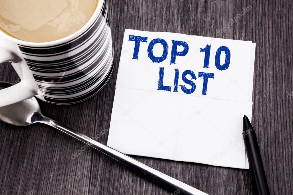 Handwritten text showing Top 10 Ten List. Business concept for Success ten list written on the tissue paper handkerchief on the wooden wood background. With marker and coffee. Office top view.