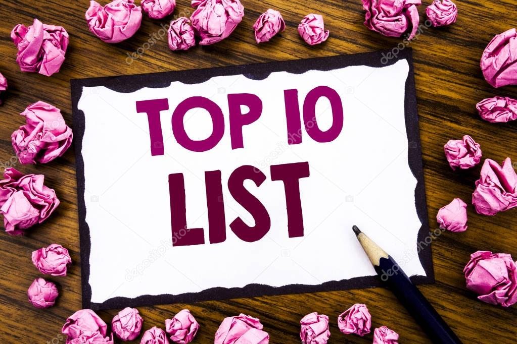 Hand writing text caption inspiration showing Top 10 Ten List. Business concept for Success ten list Written on sticky note paper, wooden background with folded pink paper meaning thinking