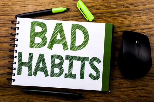 Handwriting Announcement text showing Bad Habits. Business concept for Improvement Break Habitual Hebit written on notebook book note paper on the wooden background. Green word letters. Next to mouse.