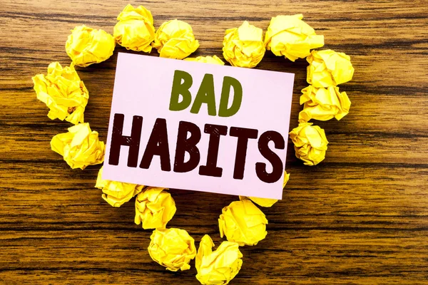 Word, writing Bad Habits. Business concept for Improvement Break Habitual Hebit written on sticky note paper on the wooden background.
