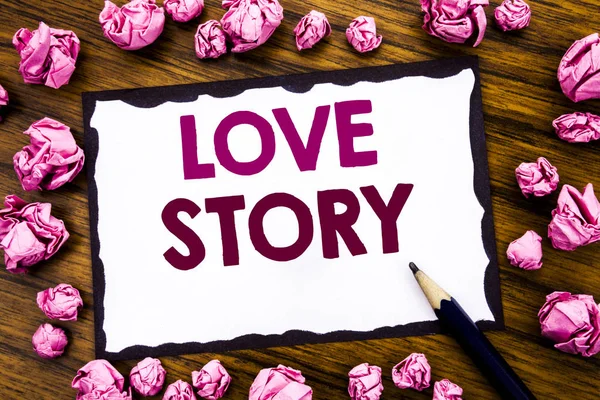 Hand writing text caption inspiration showing Love Story. Business concept for Loving Someone Heart  Written on sticky note paper, wooden background with folded pink paper meaning thinking