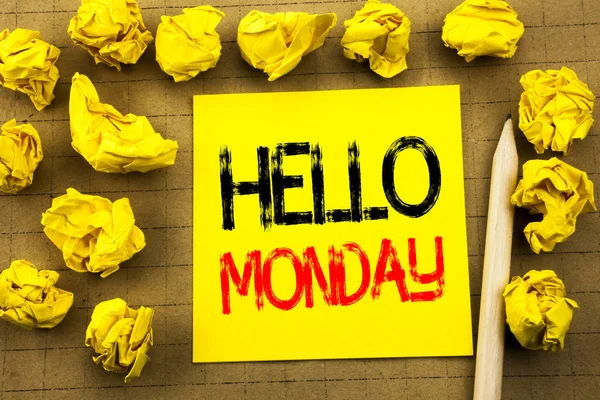Hello Monday. Business concept for Day Week Start written on sticky note paper on the vintage background. Folded yellow papers on the background