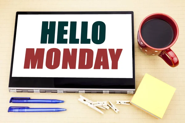Hand writing text caption inspiration showing Hello Monday. Business concept for Day Week Start written on tablet laptop. Office place with coffee cup, pen and sticky note. — Stock Photo, Image