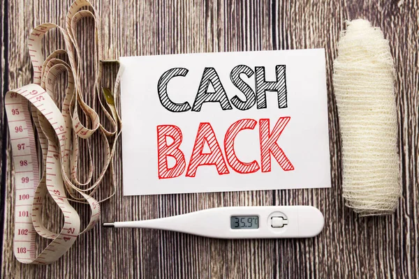 Handwritten text showing Cash Back Cashback. Business fitness health concept writing for Money Assurance written sticky note empty paper background with bandage and thermometer