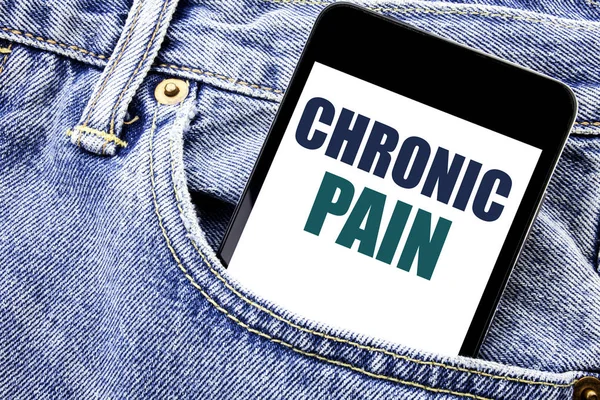 Conceptual hand writing text caption inspiration showing Chronic Pain. Business concept for Feeling Bad ill Care Written phone mobile phone, cellphone placed in the man front jeans pocket.