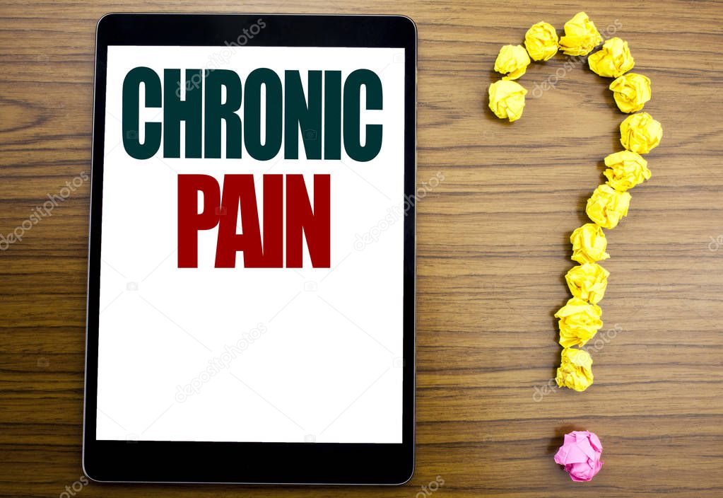 Word, writing Chronic Pain. Business concept for Feeling Bad ill Care Written on tablet, wooden background with question mark on the end.