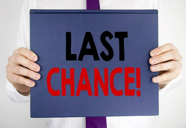 Writing text showing Last Chance. Business concept for Deadline Time Ending  written on book notebook paper holding by the man in suit blurred background.
