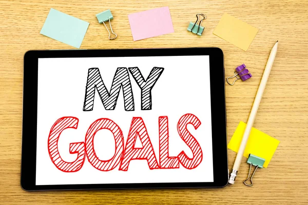 Writing text showing My Goals. Business concept for List Plan for Motivation Written on tablet laptop, wooden background with sticky note and pen
