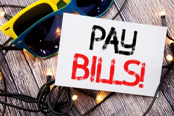 Writing text showing Pay Bills. Business concept for Finance Paying Online written on sticky note with copy space on old wood wooden background with sunglasses — Stock Photo, Image