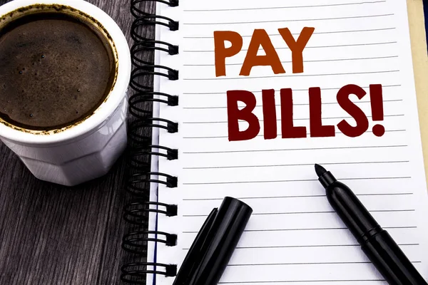 Writing text showing Pay Bills. Business concept for Finance Paying Online written on notebook book note paper on the wooden wood background. With coffee and black marker.