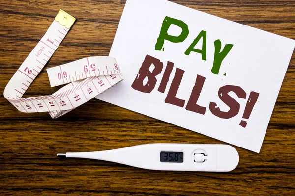 Conceptual hand writing text caption showing Pay Bills. Business concept for Finance Paying Online written on sticky note paper on wood background. Meter and thermometer for fitness subject. — Stock Photo, Image