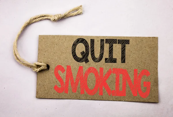 Hand writing text caption inspiration showing Quit Smoking. Business concept for Stop for Cigarette  written on price tag paper on the white vintage background. — Stock Photo, Image