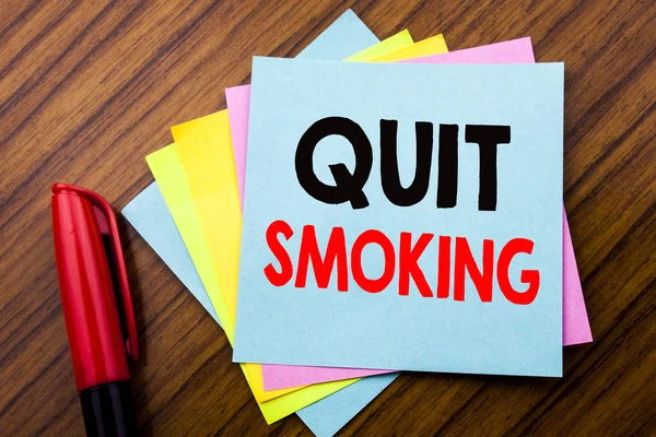 Handwriting Announcement text Quit Smoking.  Concept for Stop for Cigarette  Written on sticky stick note paper with wooden background with space office view with pencil marker — Stock Photo, Image