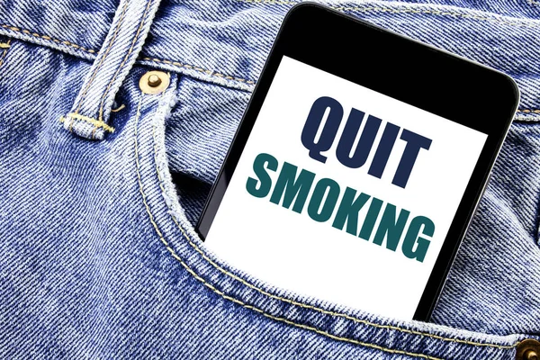 Conceptual hand writing text caption inspiration showing Quit Smoking. Business concept for Stop for Cigarette  Written phone mobile phone, cellphone placed in the man front jeans pocket.