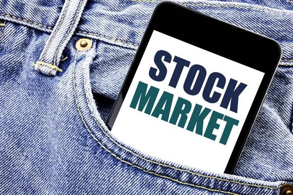 Conceptual hand writing text caption inspiration showing Stock Market. Business concept for Equity Share Exchange Written phone mobile phone, cellphone placed in the man front jeans pocket.