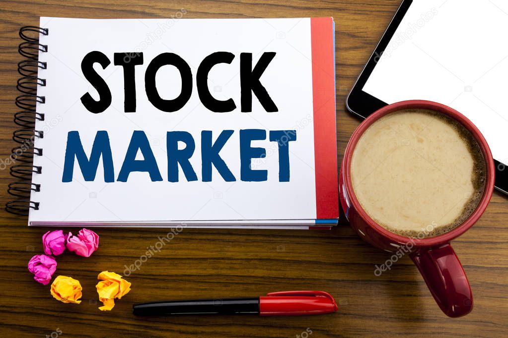 Handwritten text showing Stock Market. Business concept writing Equity Share Exchange Written on notepad note paper, old black wooden background in office view with pen coffee and tablet