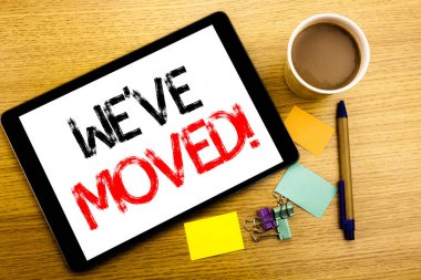 El yazısı metnini başlık var taşındı gösterilen. Yazmak için şirket değişen yer yazılı tablet laptop, yapışkan not, kahve ve kalem ile ahşap arka plan iş kavramı