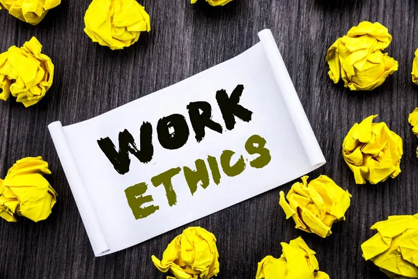 Writing text showing Work Ethics. Business concept for Moral Benefit Principles Written on sticky note notepad note notebook book wooden background with yellow sticky folded.