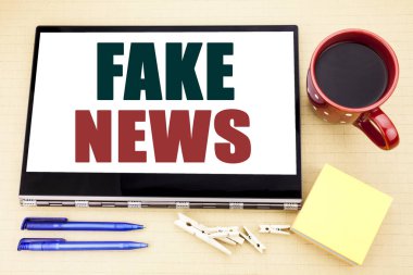Sahte haber gösterilen metin resim yazısı ilham yazma el. İş kavramı Hoax tablet dizüstü bilgisayarda yazılmış gazetecilik için. Kahve fincanı, kalem ve yapışkan not Office yer.