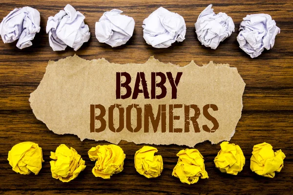 Palavra de texto mão conceitual Baby Boomers. Conceito de negócio para geração demográfica Escrito em nota pegajosa, de madeira com pegajoso, muitos papel dobrado branco e amarelo para diferença ou colaboração — Fotografia de Stock