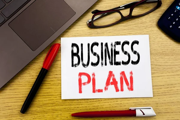 Conceptual hand writing text showing Business Plan. Business concept for Mission or Vision written on paper, wooden background in office with copy space, marker pen and glasses — Stock Photo, Image