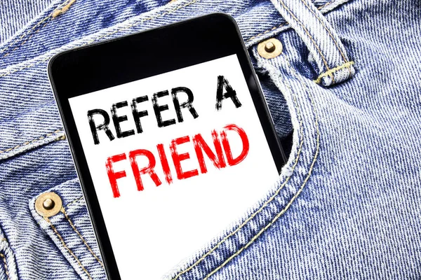 Handwriting Announcement text showing Refer A Friend. Business concept for Referral Marketing Written phone mobile phone, cellphone placed in the man front jeans pocket.