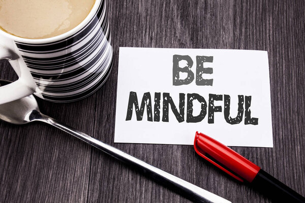 Conceptual hand writing text caption showing Be Mindful. Business concept for Mindfulness Healthy Spirit written on sticky note paper on the wooden wood background. With coffee and marker