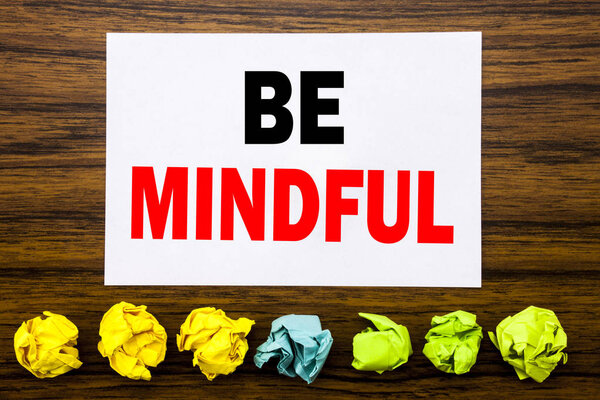 Hand writing text caption inspiration showing Be Mindful. Concept for Mindfulness Healthy Spirit Written on sticky note , with sticky, one folded paper alone for difference or collaboration