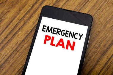 Word, el yazısı acil yardım planı yazma. İş kavramı koruma felaket yazılı cep telefonu cep telefonu üzerinde ahşap arka plan kopya alanı ile için.