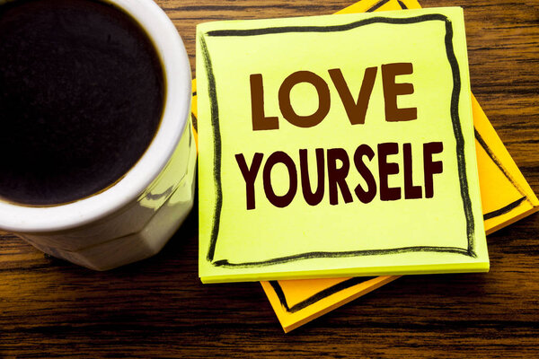 Handwritten text showing Love Yourself. Business concept for Positive Slogan For You written on sticky note paper on the wooden wood background with coffee cup