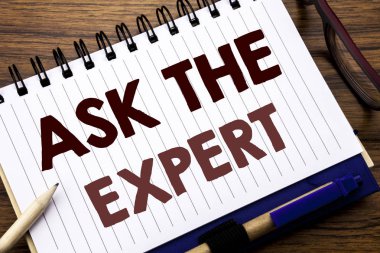 Uzman sormak gösterilen metin resim yazısı ilham yazma el. Defter not kağıdı, gözlük kalem ve marker ile ahşap arka plan üzerinde tavsiye yardım soru zaten yazıyorsa için iş kavramı.