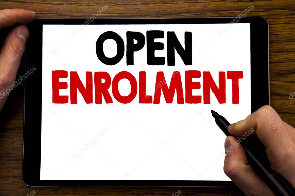 Handwriting Announcement text showing Open Enrolment. Business concept for Medicine Doctor Enroll Written on tablet laptop, wooden background with businessman hand, finger writing on PC.
