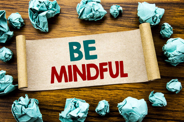 Word, writing Be Mindful. Business concept for Mindfulness Healthy Spirit Written on sticky note paper, wooden background with folded yellow paper meaning thinking